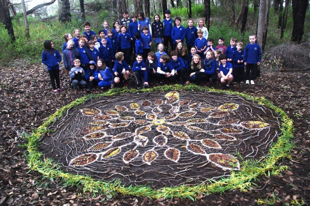 Proud Primary School Children Showing Off Their Land Art Piece 'Birds Of A Feather'