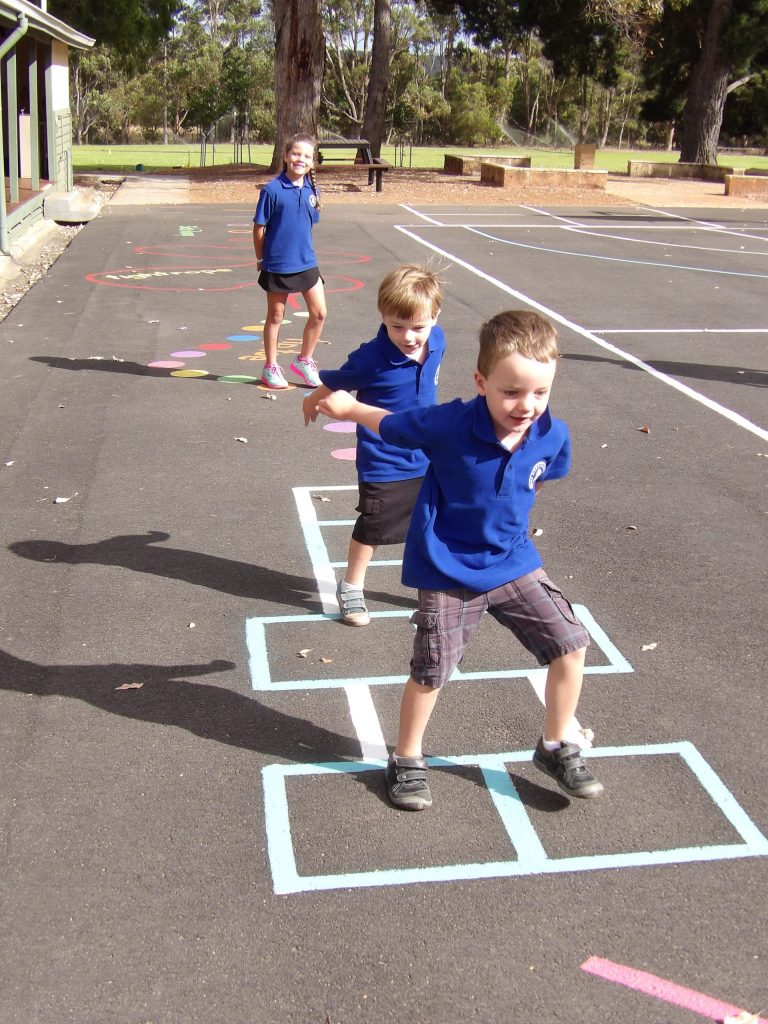 Students playing hopscotch